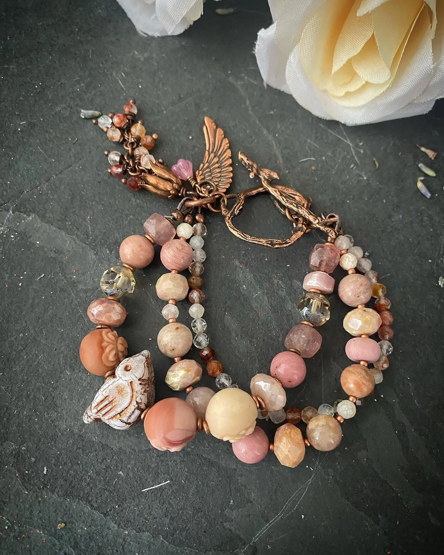 agate carved quartz, Czech glass bird, rhodochrosite stones, strawberry quartz and moonstone, Copper metal, bracelet.