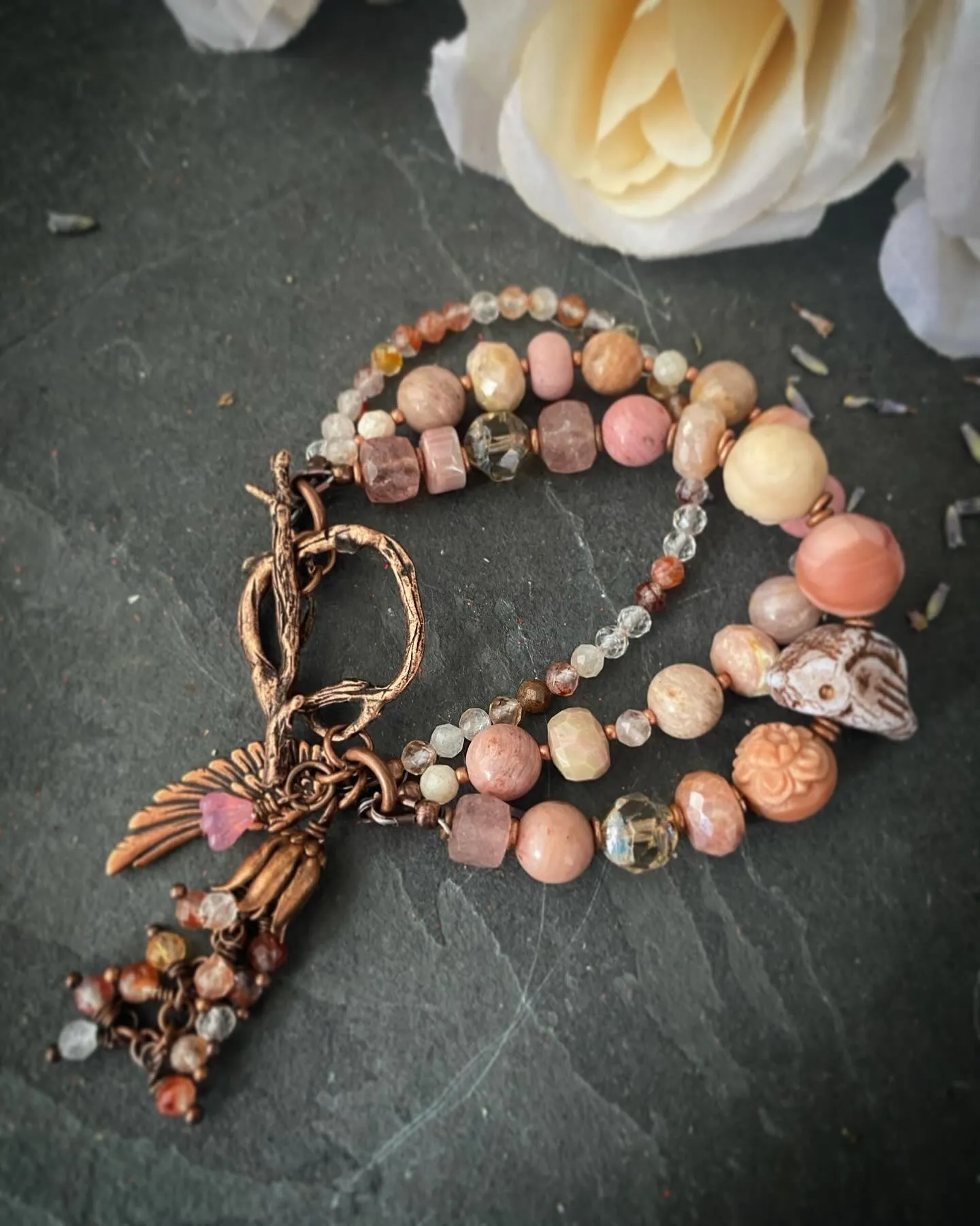 agate carved quartz, Czech glass bird, rhodochrosite stones, strawberry quartz and moonstone, Copper metal, bracelet.