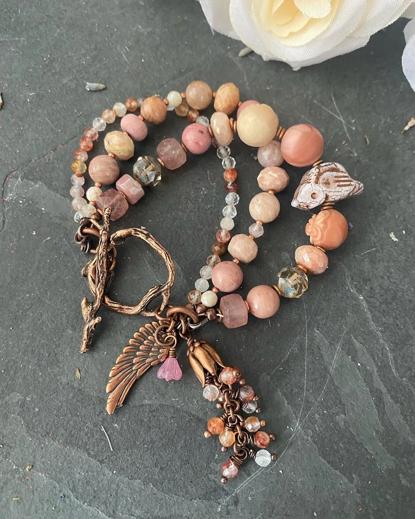 agate carved quartz, Czech glass bird, rhodochrosite stones, strawberry quartz and moonstone, Copper metal, bracelet.