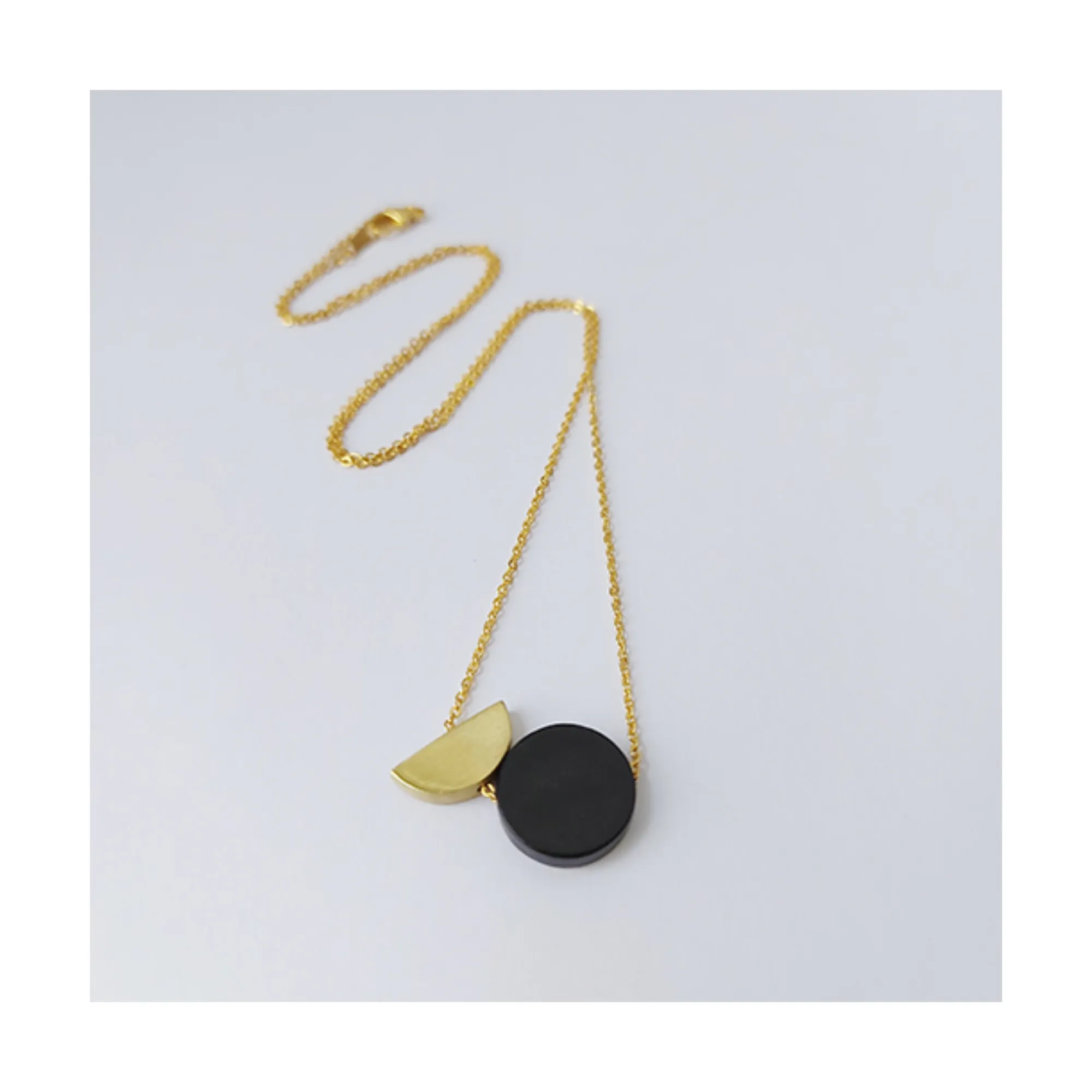 Epicycle black disc brass necklace